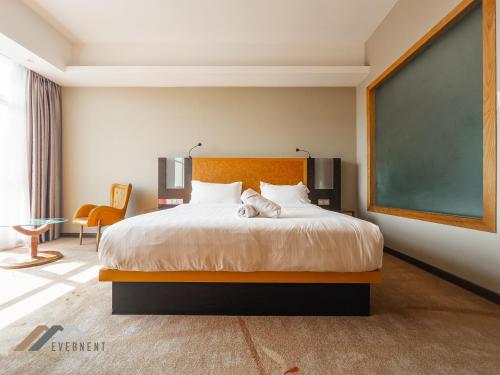 a bedroom with a large bed and a chalkboard at Evernent Meritz in Miri
