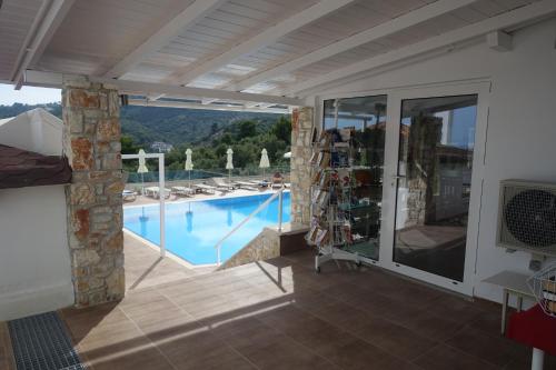 a view of a swimming pool from a house at Hotel Rene in Skiathos Town
