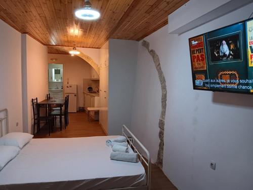 a room with a bed and a tv on the wall at Rethymno traditional Studio in Rethymno Town