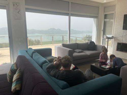 a man sitting on a couch in a living room at Jbela House 