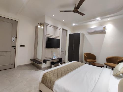 a bedroom with a bed and a flat screen tv at HOTEL Elegance 5 min walk from Golden Temple in Amritsar