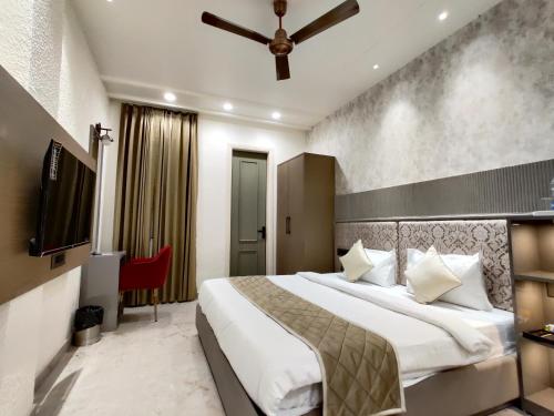 a hotel room with a bed and a television at HOTEL Elegance 5 min walk from Golden Temple in Amritsar