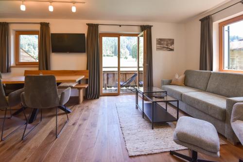 a living room with a couch and a table at Apartments Foidl in Kitzbühel
