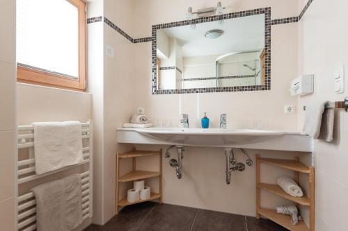 a bathroom with a sink and a mirror at Apartments Foidl in Kitzbühel