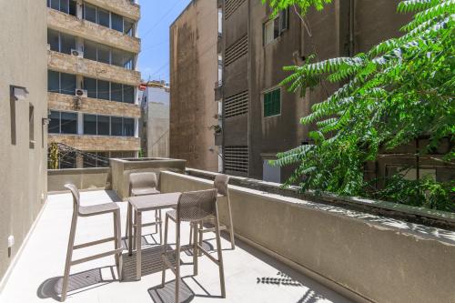 a balcony with chairs and a table on a building at CityZen - Boutique Studios in Achrafieh in Beirut
