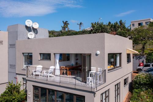 a building with a balcony with chairs on it at Apartment 18 Wenonah in Southbroom