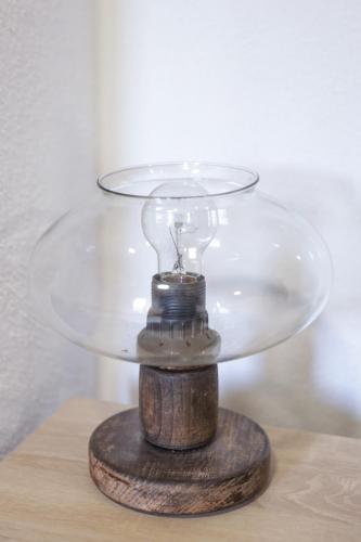 a glass bowl on top of a wooden table at Vikendica Cemerno in Gacko
