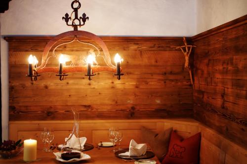 a chandelier with candles on top of a table at Hotel Der Bär in Ellmau