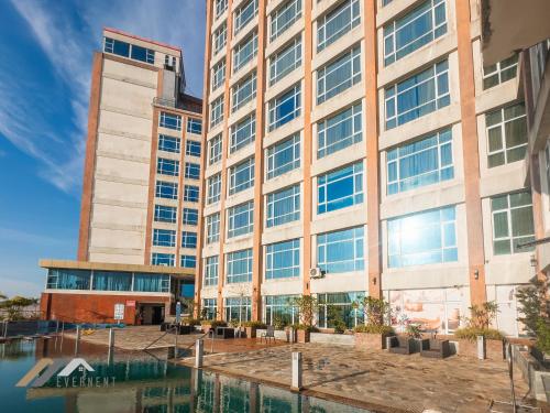 an office building with a pool in front of it at Evernent Meritz in Miri