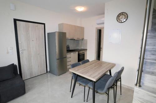 a kitchen with a table and chairs and a refrigerator at Chroidis Appartment in Sozopoli