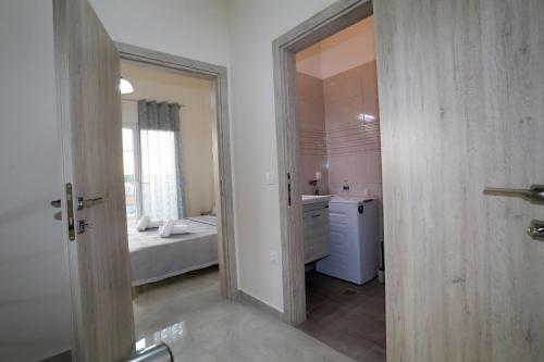 a bathroom with a bed and a sink in a room at Chroidis Appartment in Sozopoli