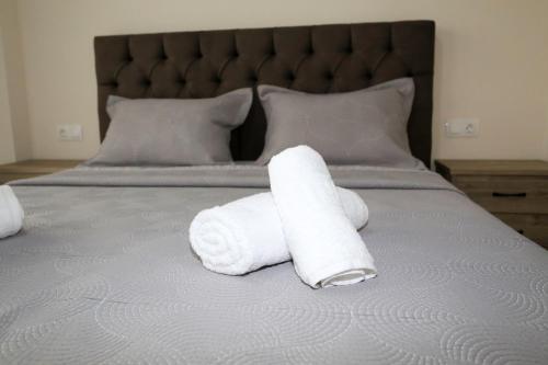 two rolls of white towels sitting on a bed at Chroidis Appartment in Sozopoli