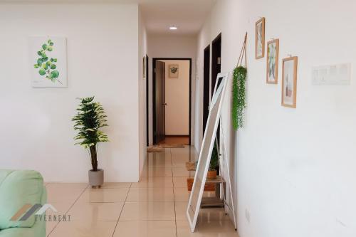 a hallway with stairs and plants in a house at Serene Heights by Evernent in Miri