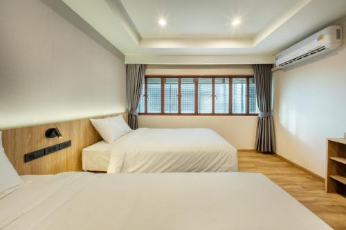 Postel nebo postele na pokoji v ubytování Thap Kaeo Poshtel City Center Korat