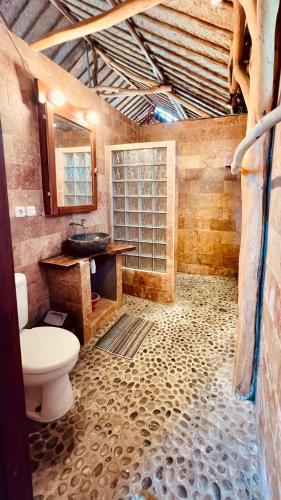 a bathroom with a toilet and a sink at Yoga bale house in Padangbai