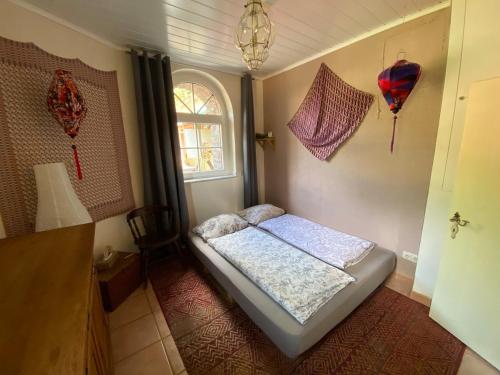 a small bedroom with a bed and a window at 2 Bedroom with Bathroom - Altbauvilla in Burgen