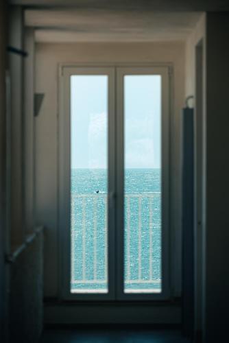 a window in a room with a view of the ocean at Hotel Approdo di Venere in Vieste