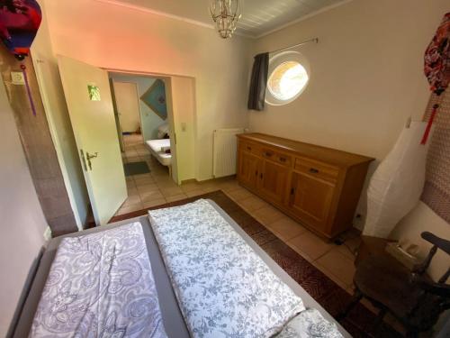 a room with a bed and a bathroom with a mirror at 2 Bedroom with Bathroom - Altbauvilla in Burgen