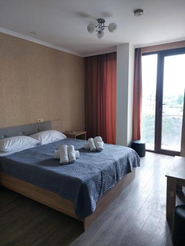 a bedroom with a bed with two towels on it at Batomi hotel in Batumi