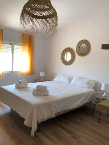 a bedroom with a large bed with towels on it at La Casica Vieja in Albujón