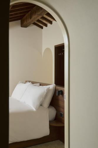 a bedroom with a bed with white pillows at Scavolo Borgo in SantʼAgata Feltria