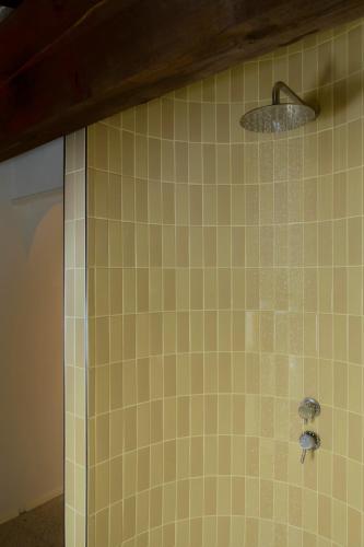 a bathroom with a shower with yellow tile at Scavolo Borgo in SantʼAgata Feltria