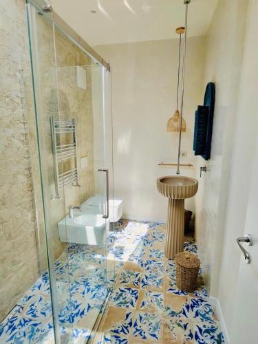 a bathroom with a glass shower and a sink at La Presentosa b&b in Fossacesia