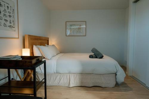 a bedroom with a large white bed and a desk at Private guest suite in Central Wanaka in Wanaka