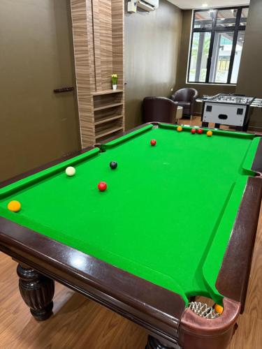 a pool table with balls on it in a room at Paradigm MarvelClassic JB Platino 3BR 10PAX in Johor Bahru