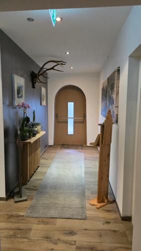 a room with a hallway with a door and a rug at Landhotel Anna in Sankt Martin am Tennengebirge