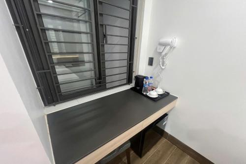 a desk with a window in a room at Thao Trang Luxury Hotel Quang Binh in Dong Hoi