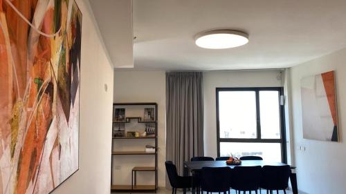 a dining room with a table and a window at JTower Royal Suites - Alefimmoed in Jerusalem