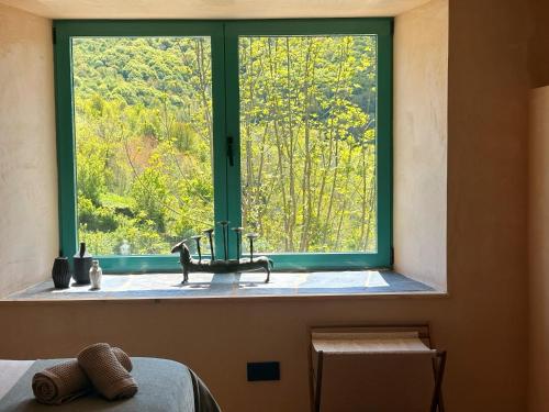 a window with a sink and a view of a forest at Casa Albaredo, Aldea Rural, Boutique Hotel, Retreat, in O Cebrero