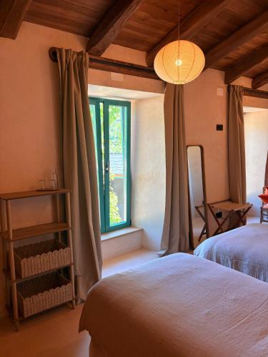 a bedroom with two beds and a window at Casa Albaredo, Aldea Rural, Boutique Hotel, Retreat, in O Cebrero