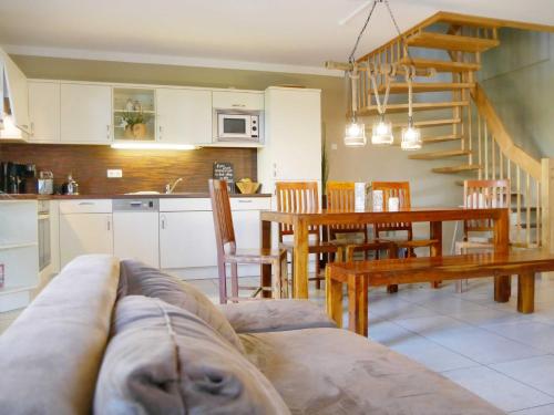 a living room and kitchen with a couch and a table at Ferienpark Scharmützelsee in Wendisch Rietz
