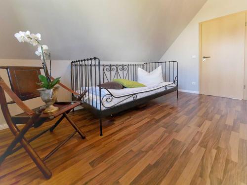 a bed in a room with a wooden floor at Ferienpark Scharmützelsee in Wendisch Rietz