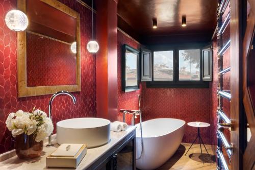 a bathroom with a large tub and a sink at The James Suite Hotel Firenze 1564 - Small Luxury Hotels of the World in Florence
