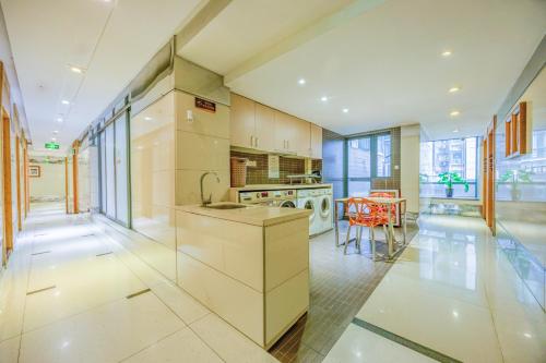 a kitchen with a sink and a stove at Guangzhou Timmy Hotel in Guangzhou