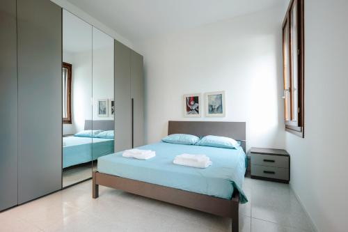 a bedroom with a bed and a large mirror at Buongiorno Vicenza! in Vicenza