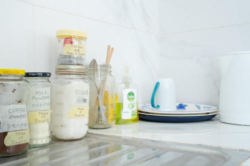 a refrigerator filled with jars and plates of food at House of Sincerity in Maharagama