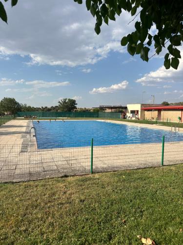 a swimming pool with a fence around it at La Fuente in Villalcampo