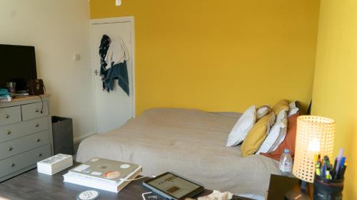 a bedroom with a bed and a desk with a night stand at 3 bedroom cosy apartment 20 mins to Centre in Moffat