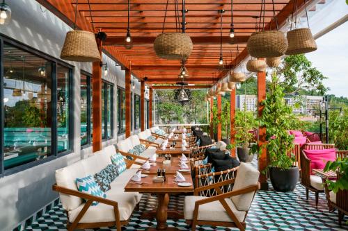 a restaurant with tables and chairs on a patio at The RIYAZ Lavanya Langkawi in Pantai Cenang