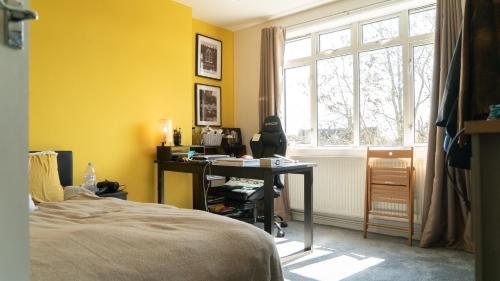 a bedroom with a bed and a desk and a window at 3 bedroom cosy apartment 20 mins to Centre in Moffat