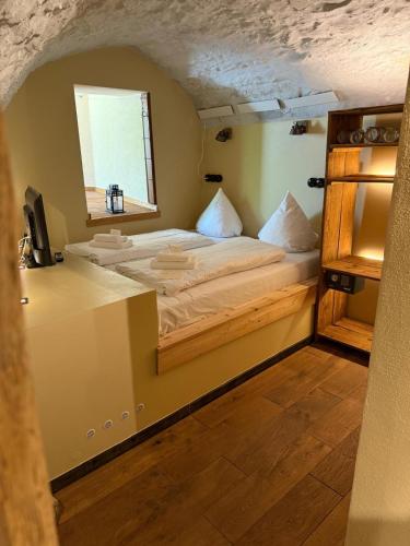 a bedroom with a bed in a room with a window at Boutique-Hotel Stadtherberge Wetzlar in Wetzlar