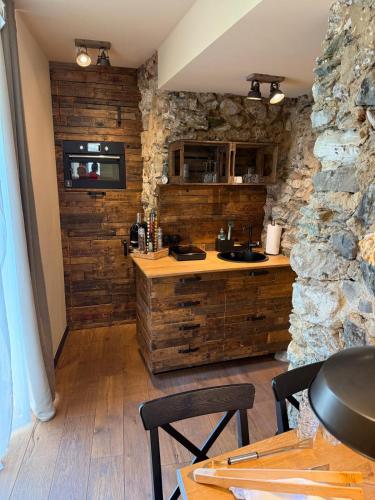 a kitchen with wooden walls and a stone wall at Boutique-Hotel Stadtherberge Wetzlar in Wetzlar