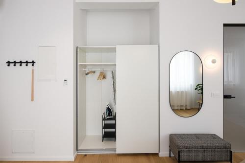 a white room with a mirror and a chair at Hiša Barbara in Celje