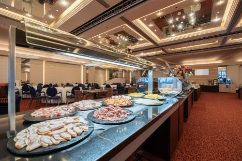a buffet line with many plates of food on it at Grand Hotel Amrâth Kurhaus The Hague Scheveningen in Scheveningen
