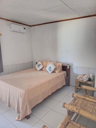 a bedroom with a bed with pillows on it at Hendi Homestay in Gili Gede