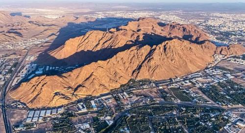 an aerial view of a mountain and a city at فندق سما المدينة in Al Madinah